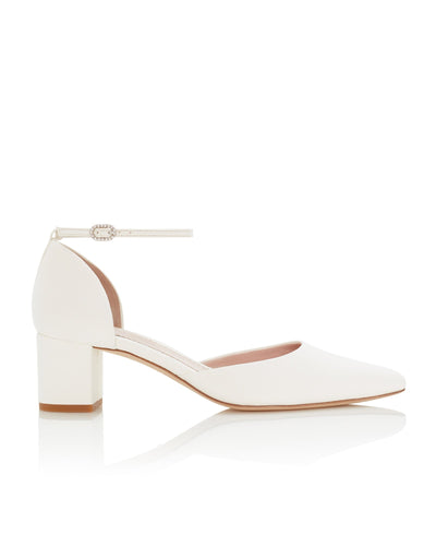 White block-heeled shoes with a pointed toe and ankle strap, set against a clean white background. The heel height is approximately 2.5 inches, and the material is likely leather. The shoes are displayed at a slight angle to showcase the design.
