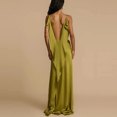 Woman wearing a green evening gown with a deep back on a beige background
